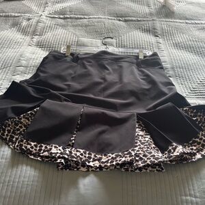 Daily Sports Black golf skort with Patterned Hem.